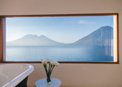 Cast iron bathtub with lake view in Room One at Anzan Atitlán, creating a seamless connection with Lake Atitlán.