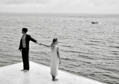 Couple dancing at the edge of the Lake Atitlán at golden hour, intimate wedding venue in Guatemala