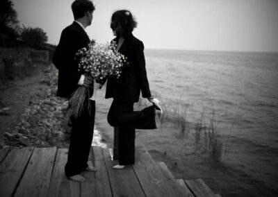 bride adjusting her shoe, lakefront private wedding ceremony
